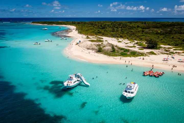 a group of people on a beach near a body of water