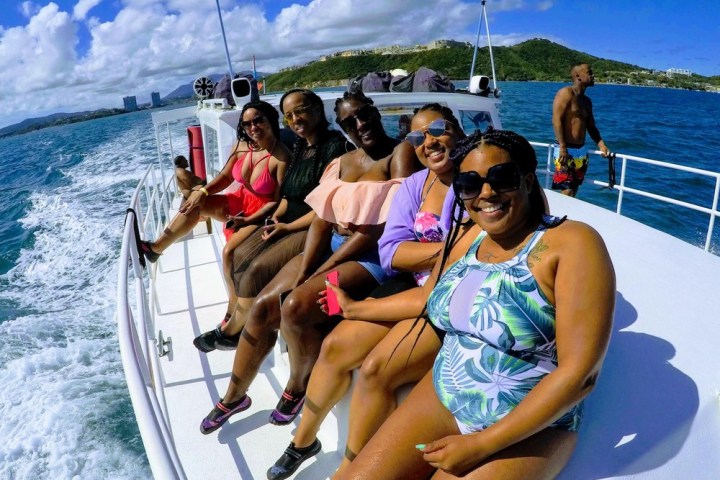 a group of people riding on the back of a boat