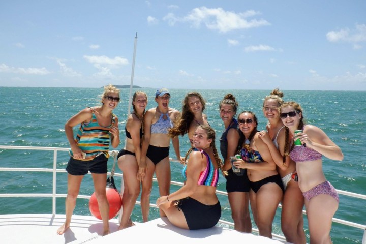 a group of people on a beach posing for the camera