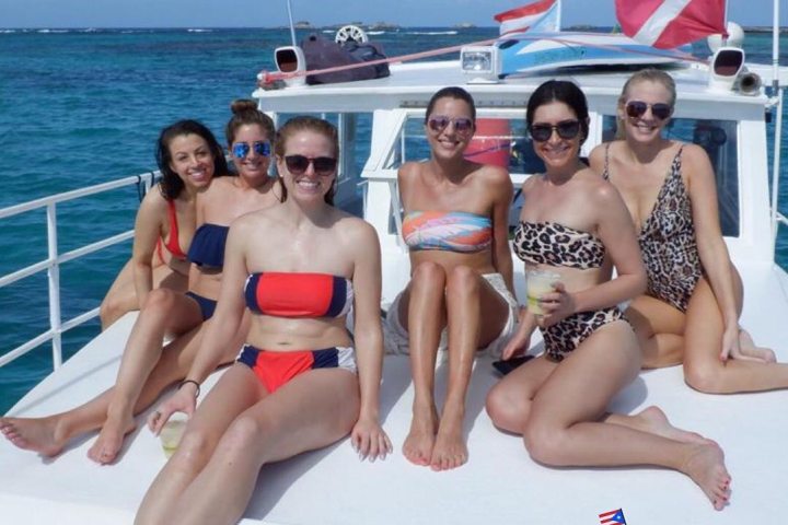 a group of people sitting at a private charter boat