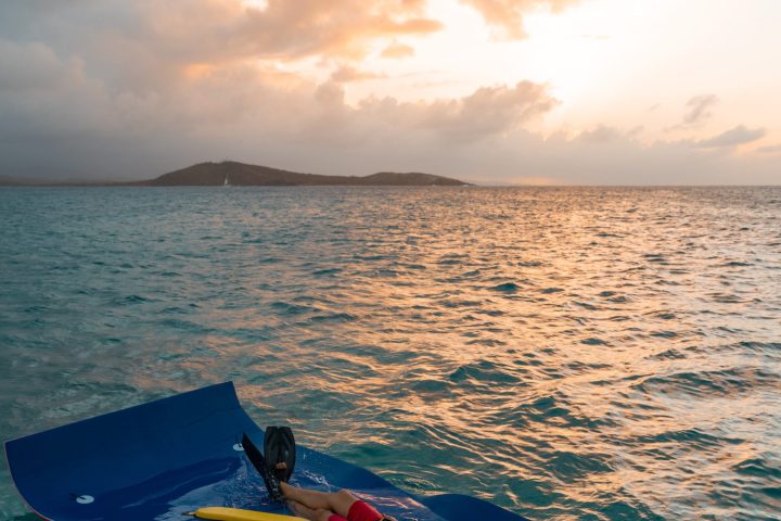 a person riding a surf board on a body of water