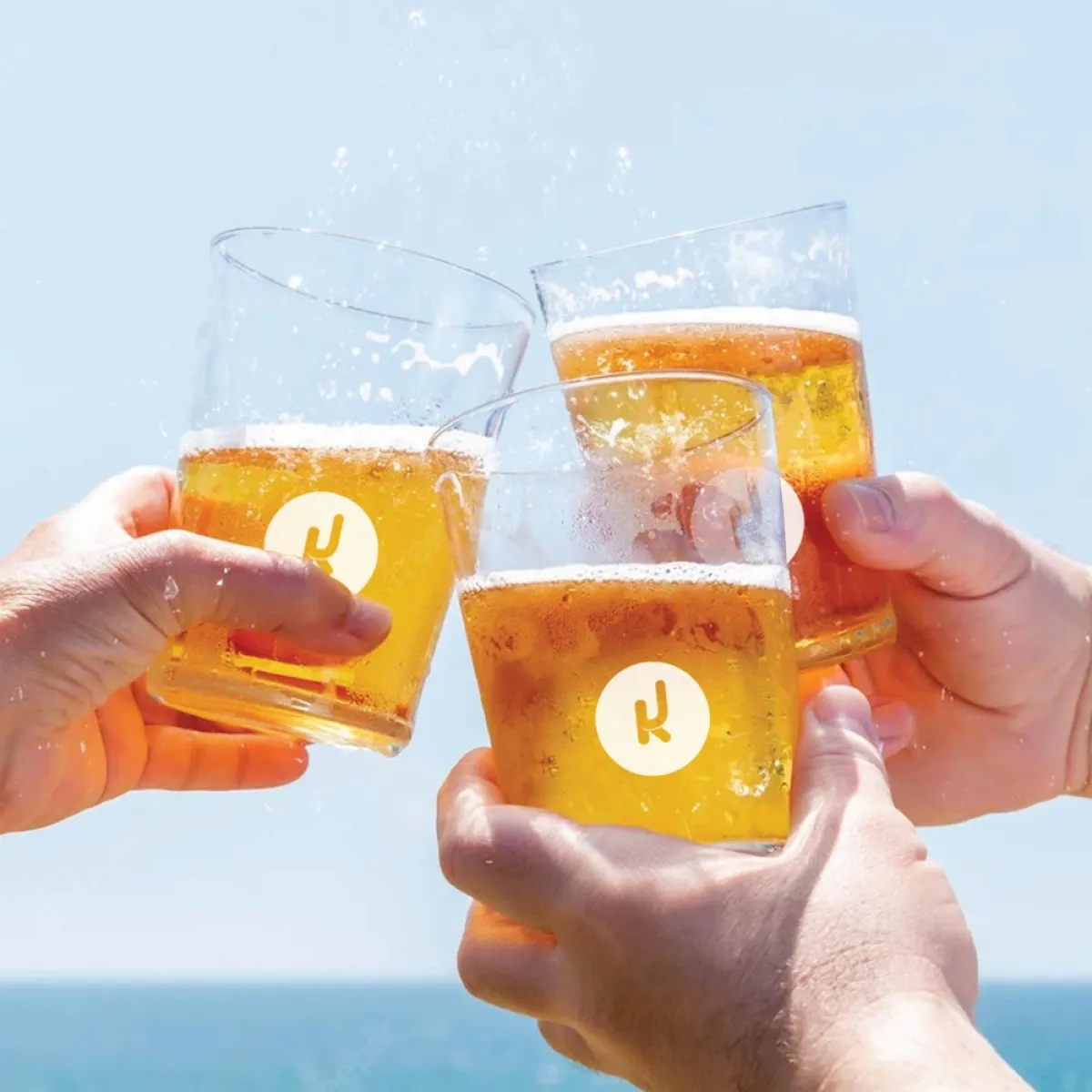 a hand holding a glass of orange juice